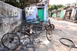 A part of the Muslim locality in Telinipara with burned vehicles owned by Muslims. Hindu mobs set fire to the entire Muslim locality on May 12, during communal violence. (Shaikh Azizur Rahman/VOA)