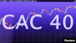 FILE - An electronic screen shows CAC 40 stock information is seen in the market services surveillance room center at the Euronext headquarters near Paris.