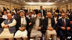  Afghan politicians, from second left to right, Mohammad Karim Khalili, Gulbuddin Hekmatyar, Haneef Atmar and Ustad Atta Mohammad Noor, and others attend the opening session of an Afghan Peace Conference, Bhurban, Pakistan, June 22, 2019.