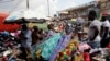 FILE - Pedestrians shop for clothes at Mokolo Market in Yaounde, Cameroon.
