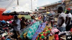 FILE - Pedestrians shop for clothes at Mokolo Market in Yaounde, Cameroon.