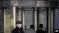 A police officer outside St Bartholomew's Hospital in London, March 1, 2021, as Prince Philip has been transferred to another London hospital to undergo testing and observation for a pre-existing heart condition and treatment for an unspecified infection.