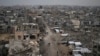 Palestinians walk amid the rubble of destroyed homes and buildings in the Zeitoun neighborhood of Gaza City, March 7, 2025.