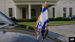 FILE - An Israeli flag is seen on one of the vehicles in Israeli Prime Minister Benjamin Netanyahu's motorcade during one of his meetings with President Barack Obama at the White House in Washington.