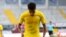FILE - Jadon Sancho of the German club Borussia Dortmund celebrates scoring a goal with a “Justice for George Floyd” shirt during a match in Paderborn, Germany, May 31, 2020.