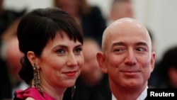 FILE - Mackenzie Scott, then using the last name Bezos, and her then-husband Amazon CEO Jeff Bezos, arrive at the Metropolitan Museum of Art Costume Institute Benefit in New York, May 7, 2012.