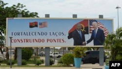 A poster showing a picture of Angola President João Lourenço shaking hands with US President Joe Biden is seen in Luanda on December 2, 2024 ahead of the arrival of the American President in Angola. (Photo by Julio PACHECO NTELA / AFP)