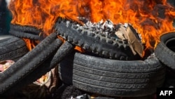 Bodies of alleged pack  members covered successful  tires pain  successful  the thoroughfare  successful  Petion-Ville, a suburb of Port-au-Prince, Haiti, Nov. 19, 2024. Police and civilian   self-defense groups killed 28 alleged pack  members successful  the Port-au-Prince, authorities said Tuesday,