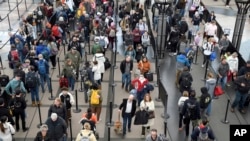 ARCHIVO - Pasajeros esperan en una fila de seguridad en el Aeropuerto Internacional de Denver el miércoles 22 de febrero de 2023. 