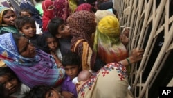 Pakistani villagers wait outside a hospital for blood screening for HIV in a village near Ratodero, a small town in southern province of Sindh in Pakistan, May 16, 2019. 