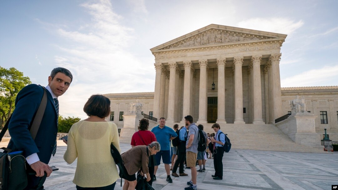 Visitors line up at the Supreme Court in Washington as the justices prepare to hand down decisions, June 17, 2019. 