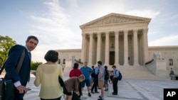 Visitors line up at the Supreme Court in Washington as the justices prepare to hand down decisions, June 17, 2019. 