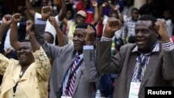 Delegates celebrate after Zimbabwean President Robert Mugabe was dismissed as party leader at an extraordinary meeting of the ruling ZANU-PF's central committee in Harare, Zimbabwe, Nov. 19, 2017.