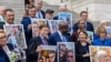 Senate Democrats hold up photographs of families who have conceived children through IVF, ahead of a Senate vote on the 'Right to IVF' bill, introduced by U.S. Senator Tammy Duckworth, on Capitol Hill in Washington, Sept. 17, 2024.