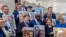 Senate Democrats hold up photographs of families who have conceived children through IVF, ahead of a Senate vote on the 'Right to IVF' bill, introduced by U.S. Senator Tammy Duckworth, on Capitol Hill in Washington, Sept. 17, 2024.