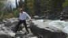 FILE - During a visit to Kyrgyzstan, Russia's President Vladimir Putin crosses a stream in Ala-Archa National Park, south of Bishkek, May 28, 2013.