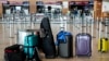 Passengers' luggage is on the floor at the Berlin-Brandenburg airport, during the airports warning strike, March 10, 2025