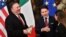 U.S. Secretary of State Mike Pompeo, left, holds a package of Parmesan cheese as Italy's Prime Minister Giuseppe Conte reacts, after the package was handed to Pompeo by Italian journalist Alice Martinelli, right, in Rome, Oct. 1, 2019. 