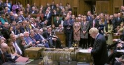 FILE - Britain's Prime Minister Boris Johnson delivers a statement to lawmakers inside a crowded House of Commons in London, Oct. 19, 2019.