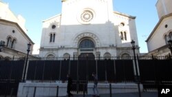 Two men walk in front of the synagogue in Marseille, southern France, Jan. 13, 2016. An attack on a man wearing a kippah has sparked debate on whether Jewish males should wear the skullcap in recognition of their faith.