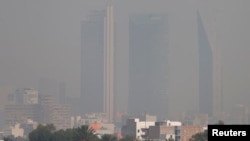 Buildings are pictured shrouded in smog in Mexico City, Mexico, May 3, 2016.