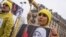 FILE - A demonstrator poses with a symbolic rope around her neck as Iranian opposition protesters march during a rally to protest against executions in Paris, France.