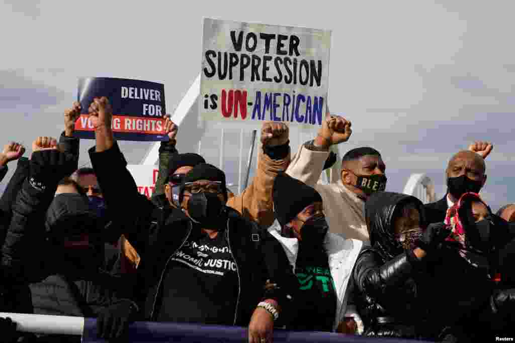 U.S. civil rights activists hold a Peace Walk on the Frederick Douglass Memorial Bridge to urge Democrats to pass a law protecting voting rights during Martin Luther King Jr. Day, in Washington.