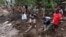FILE - Members of the Malawian Army and locals help the community to recover bodies of victims in Chimwankhunda township in the aftermath of Tropical Cyclone Freddy in Blantyre, Malawi, March 17, 2023.