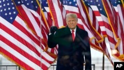 FILE - Then-President Donald Trump arrives to speak at a rally in Washington, Jan. 6, 2021.