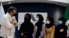 The Mexican Secretary of Foreign Affairs Marcelo Ebrard (L) welcomes four Afghan women, members of the Afghanistan Robotic team, during their arrival to Mexico after asking for refuge, at the Airport in Mexico City, on August 24, 2021.