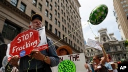 Climate change activists march in downtown Philadelphia ahead of the Democratic National Convention, July 24, 2016. 