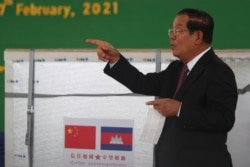 Cambodian Prime Minister Hun Sen gestures during a handover ceremony at Phnom Penh International Airport, in Phnom Penh, Cambodia, Feb. 7, 2021.