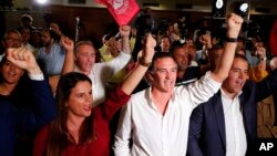 Supporters of Portuguese Prime Minister and Socialist Party leader Antonio Costa react following the announcement of first election results in Lisbon, Oct. 6, 2019. 