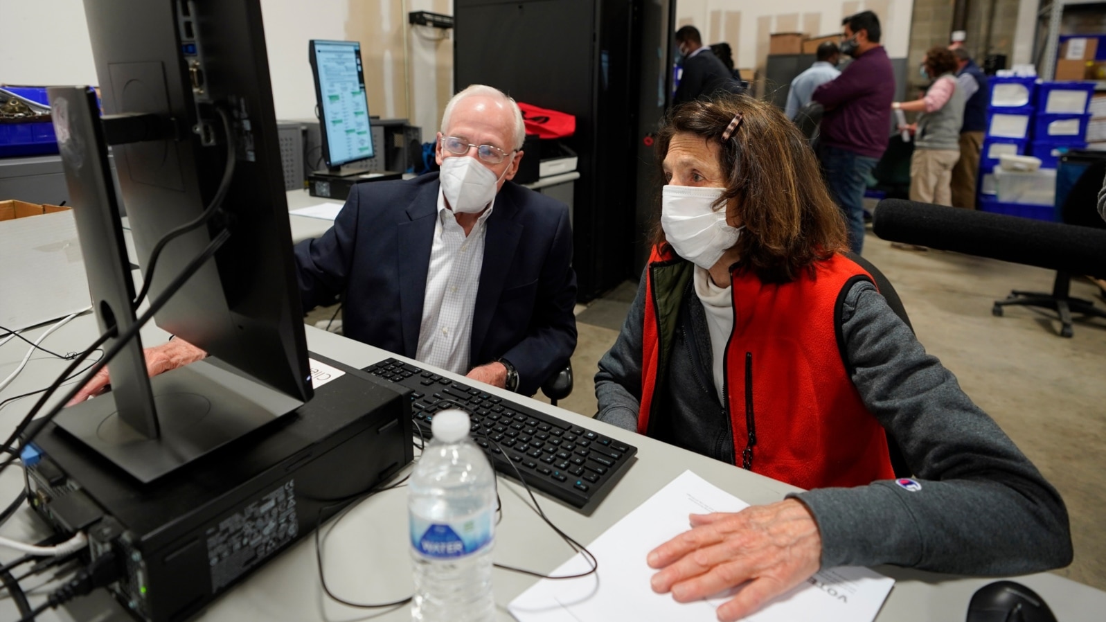 Democratic and Republican representatives review absentee ballots at the Fulton County Election preparation Center, Nov. 4, 2020 in Atlanta. 