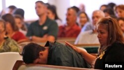 A graduating senior from Santa Fe High School reacts to Friday's school shooting during prayer services at the Arcadia First Baptist Church in Santa Fe, Texas, May 20, 2018.