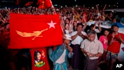 Supporters of Myanmar's National League for Democracy party celebrate as election results are posted outside the NLD headquarters in Yangon, Myanmar, Nov. 9, 2015. 