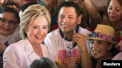 FILE - Democratic U.S. presidential candidate Hillary Clinton poses with supporters after a "Latinos for Hillary" rally in San Antonio, Texas, Oct. 15, 2015. 