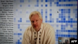 FILE - Julian Assange speaks during a teleconference between London and Washington.