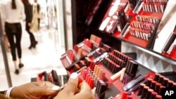 FILE - Cosmetic products are prepared for display inside a department store in New York, May 22, 2018.