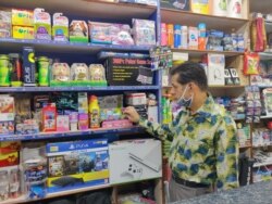 Owner of a toy and sports shop, Kailash Rohra, says big festive crowds are still missing but he hopes that will change. (Anjana Pasricha/VOA)