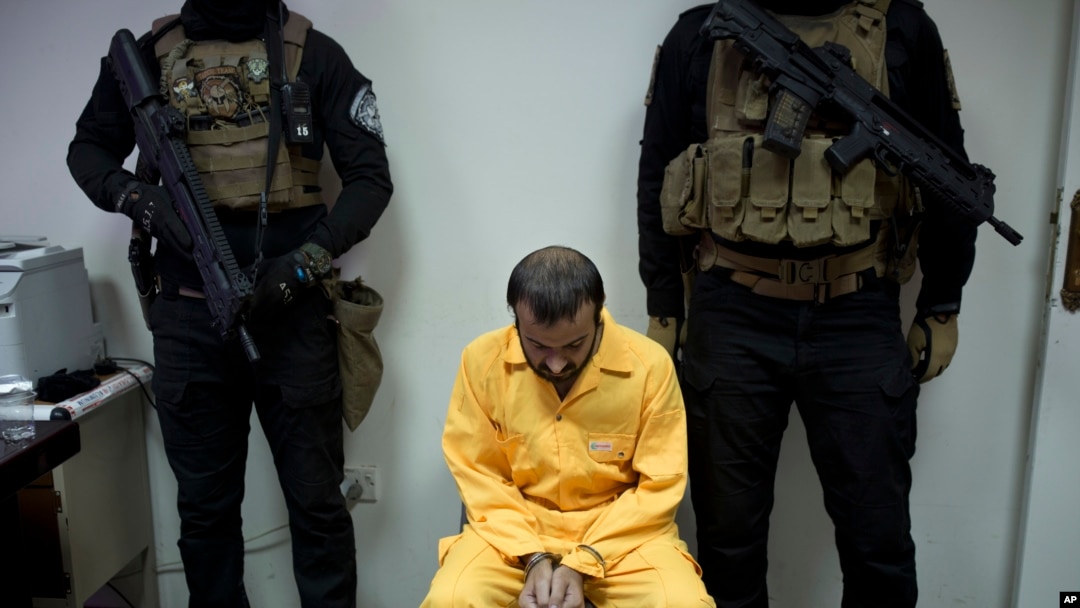 FILE - Abu Hareth, an Iraqi Islamic State preacher who owned Yazidi slaves, is seen under guard by Iraqi special forces before an interview, in Baghdad, Iraq, Aug. 28, 2019. 