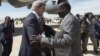 South Sudanese Foreign Minister Barnaba Marial Benjamin, right, welcomes US Secretary of State John Kerry upon his arrival at Juba International Airport, South Sudan, Friday May 2, 2014. Kerry, landing in the capital Juba on Friday, has threatened U.S.sanctions against South Sudanese leaders. 