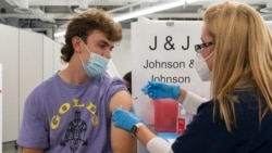 In this July 30, 2021 file photo, Bradley Sharp, of Saratoga, N.Y., gets the Johnson & Johnson vaccine from registered nurse Stephanie Wagner, in New York. Sharp needs the vaccination because it is required by his college. Hundreds of college campuses across the country have told students that they must be fully vaccinated against COVID-19 before classes begin in a few weeks. (AP Photo/Mark Lennihan, File)