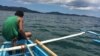 Fishermen sail past the Ulugan and Oyster Bay navy bases into waters of the South China Sea, Sept. 15, 2014. (Jason Strother/VOA)