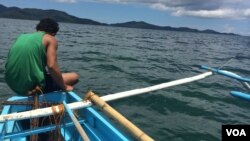 FILE - Vietnam, China and the Philippines all claim at least a portion of the Spratly archipelago. Here, a fisherman sails into waters of the South China Sea, Sept. 15, 2014.