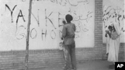 A resident of Tehran washes "Yankee Go Home" graffiti from a wall in the capital city of Iran, Aug. 21, 1953. The new Premier Gen. Fazlollah Zahedi requested the cleanup after the coup d'etat, which restored the Shah of Iran in power.