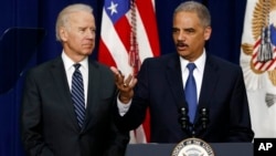 Vice President Joe Biden (left) with Attorney General Eric Holder April 9, 2013