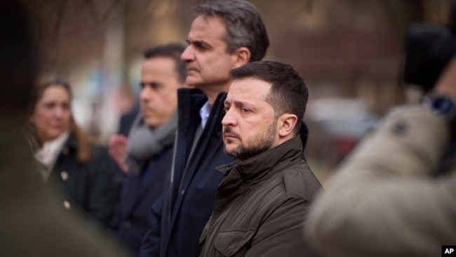 In this photo provided by the Ukrainian Presidential Press Office, Ukrainian President Volodymyr Zelenskyy, center right, and Greece's Prime Minister Kyriakos Mitsotakis visit a place of Russian attack at a residential area on March 2, in Odesa, March 6, 2024.