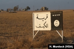 While coalition airstrikes rain down on IS in Mosul, soldiers say the Iraqi Army's southern front is largely a ground operation pushing slowly towards the city. This old IS road sign at least 50 kilometers from Mosul still stands, saying "The Village of Kahf" along with standard Muslim devotions.