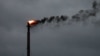 FILE - Smoke rises from a burn off at an oil refinery in Corpus Christi, Texas, on Aug. 26, 2017. Oil production in the United States rose to a record 13.46 million barrels per day in October 2024, the U.S. Energy Information Administration said on Dec. 31, 2024.